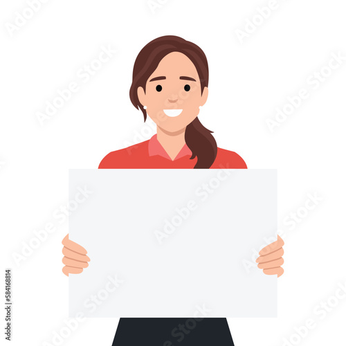 Young beautiful woman smiling and holding a blank / empty sheet of white paper or board. Woman showing a empty poster. Human emotion & body language concept
