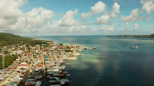 Freight ships and ferries in the bay, top view. Dapa Ferry Terminal. Siargao, Philippines. photo