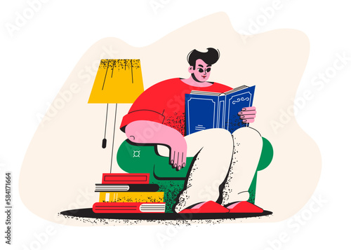 A young man is reading a book. A student is sitting in an armchair with a book. Library, bookstore