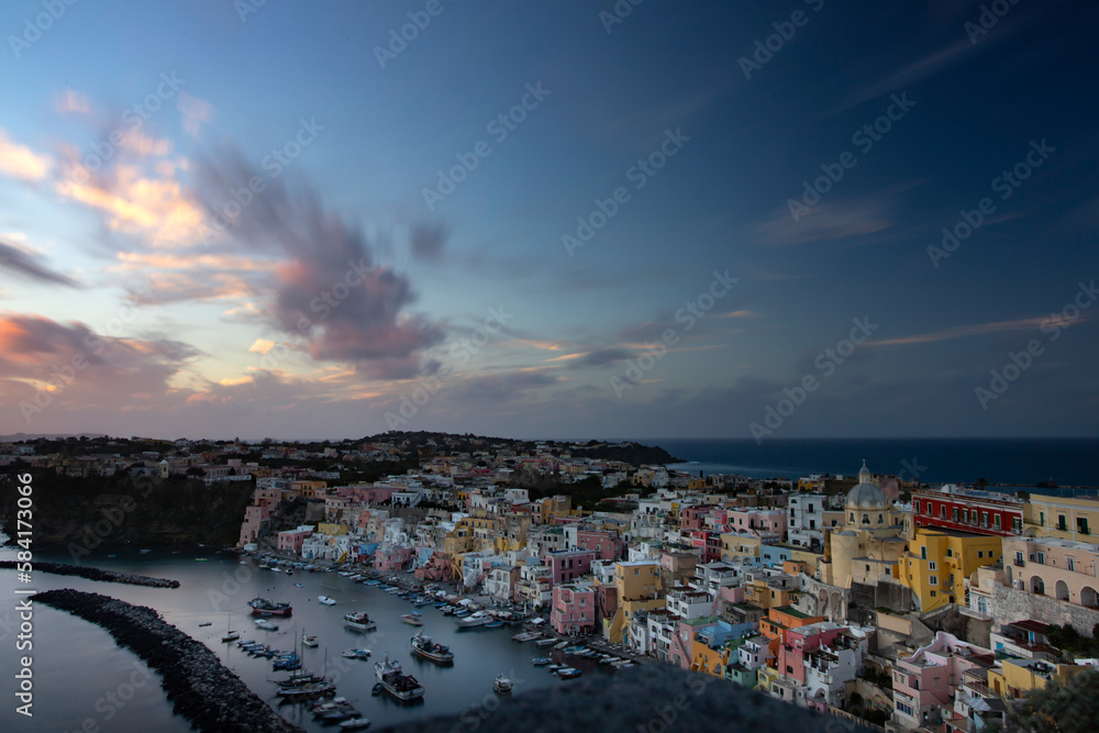Beautiful fishing villagein magic sunset, Marina Corricella on Procida Island, Bay of Naples, Italy.