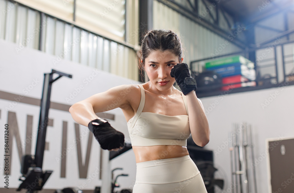 Asian young muscular fit strong body sporty athletic sexy female fitness in  sportswear sport bra leggings gloves standing guarding footwork boxing  training exercising punching workout in Crossfit gym Stock Photo