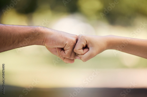 Teamwork, fist bump and people with outdoor support, collaboration and team building mission or agreement. Man, woman partner or couple of friends with deal, challenge or power hands sign in a park © Sharne T/peopleimages.com