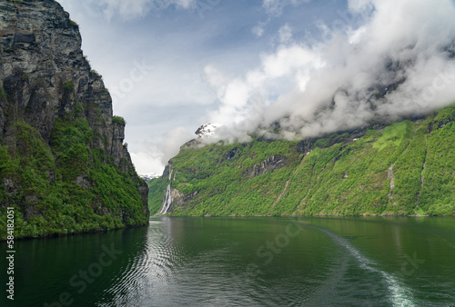 Beautiful landscape with snowy mountain peaks and waterfalls in Geiranger fjord, Norway