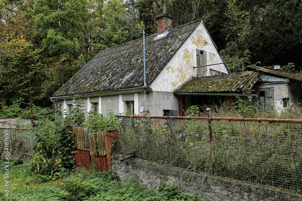 Old abandoned house with scrubby garden by the forest Old abandoned house with scrubby garden by the forest