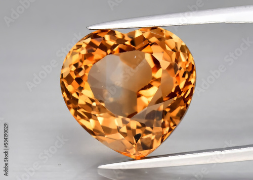 Photography Natural gemstone orange topaz imperial on a gray background