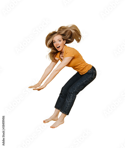 Cute redhead woman, dressed in orange t-shirt and black jeans jumping with fluttering hair, smiling wide, excited, over transparent background, holiday shopping. Shopping and sales concept.