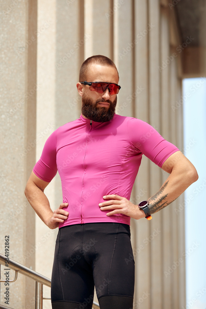 Portrait of man resting after workout outdoors, fit man standing on modern bridge, sportsman resting after training outdoors Portrait of man resting after workout outdoors, fit man standing on modern bridge, sportsman resting after training outdoors