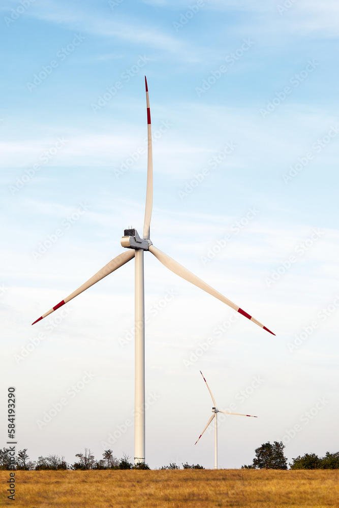 Silhouette of wind turbines at sunset. The concept of alternative energy. Silhouette of wind turbines at sunset. The concept of alternative energy.