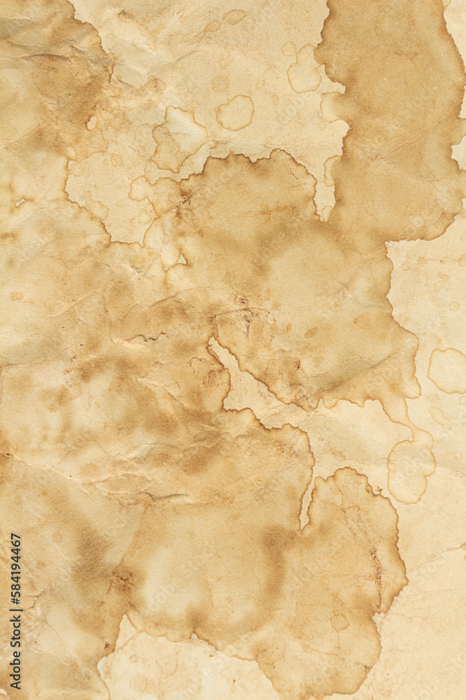 Fototapeta premium Old brown wrinkled paper coffee stains, dirty paper texture, coffee paper on the background.