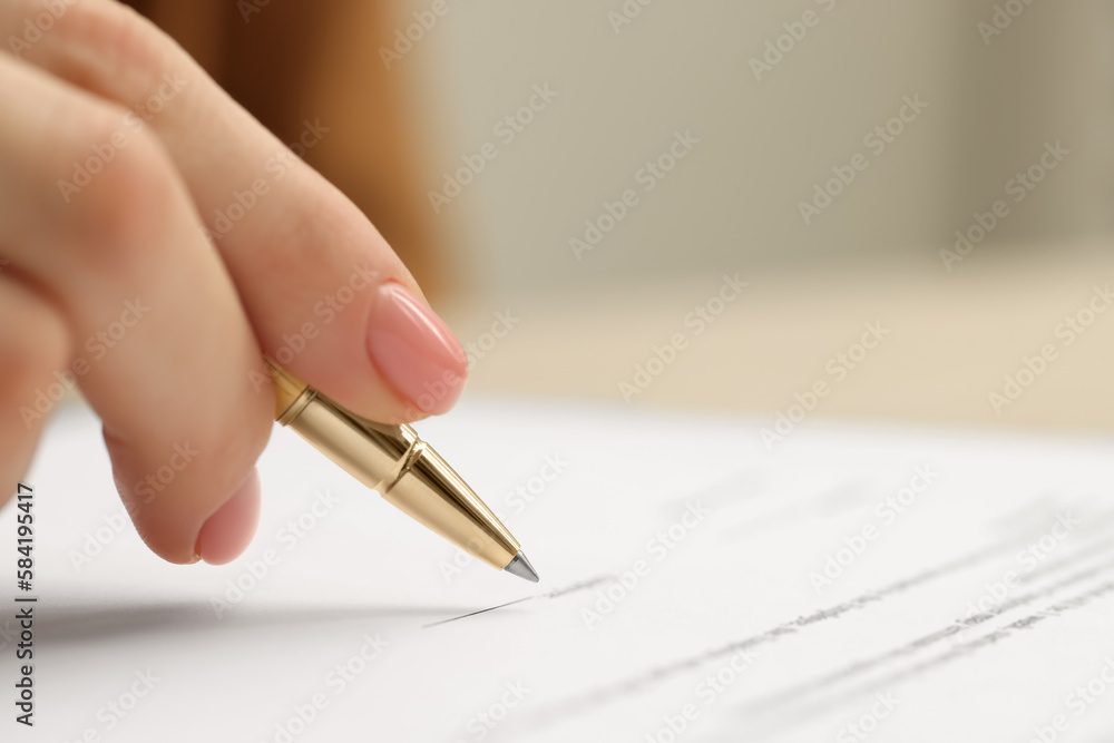 Woman signing document, closeup view. Space for text Woman signing document, closeup view. Space for text