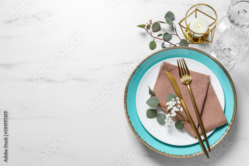 Stylish table setting with cutlery  flower and eucalyptus leaves  flat lay. Space for text