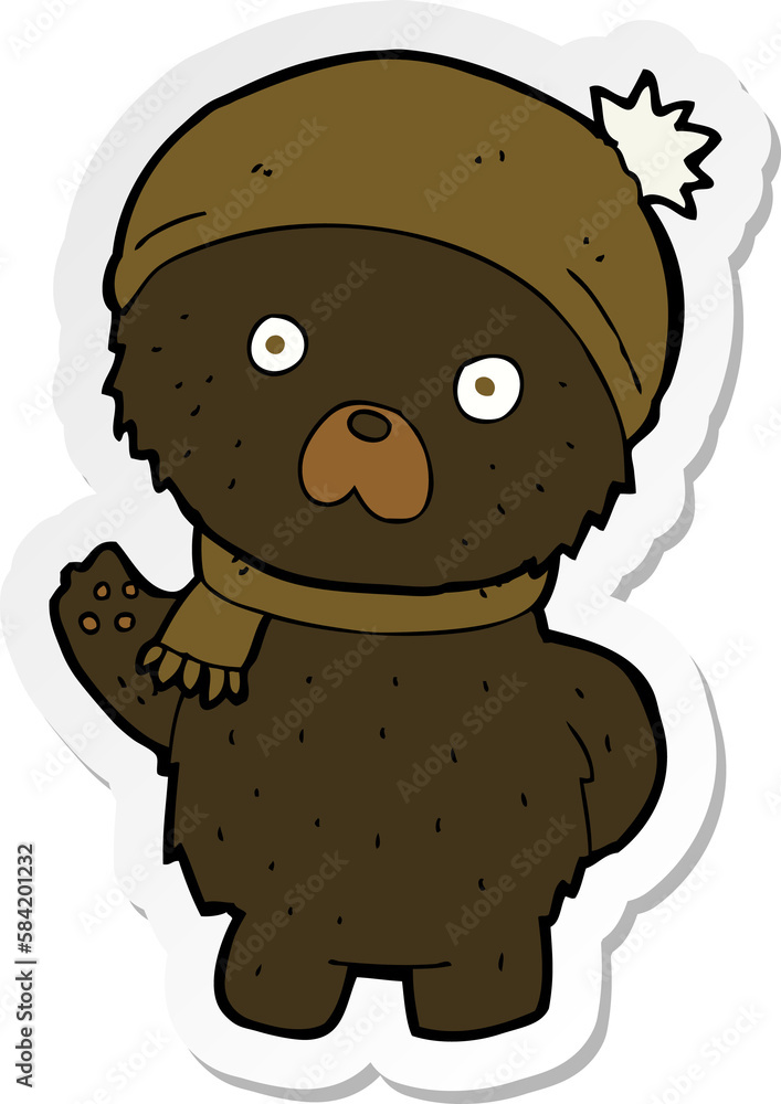 Fototapeta premium sticker of a cartoon cute black bear in winter hat and scarf