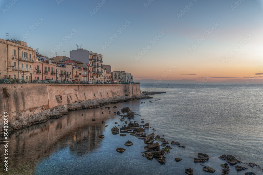 Syracuse Sicily. The dawn of a new day on the beautiful seafront of Ortigia
