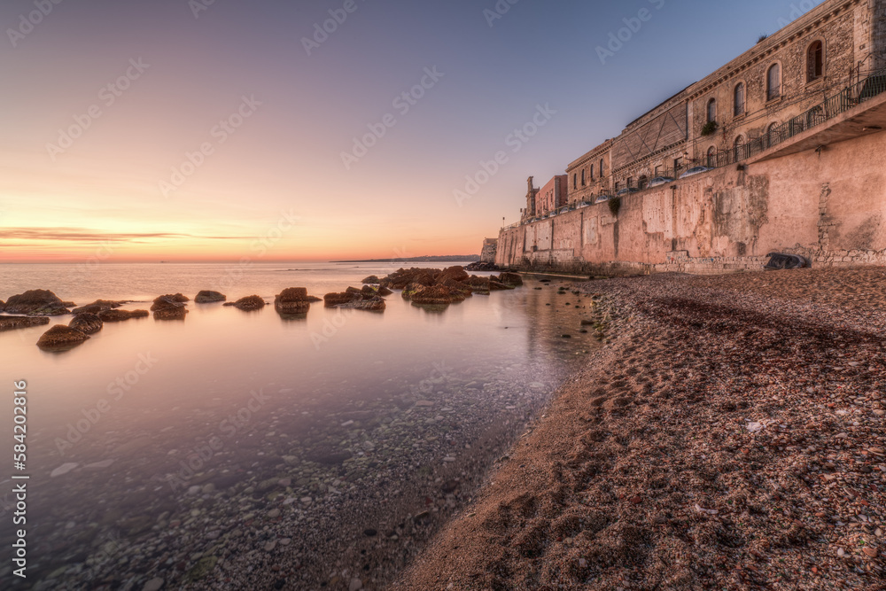The breathtaking scenery of the Ortigia seafront in Syracuse Sicily in  the sunrise of a new day