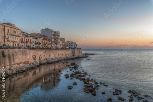 Syracuse Sicily. The dawn of a new day on the beautiful seafront of Ortigia