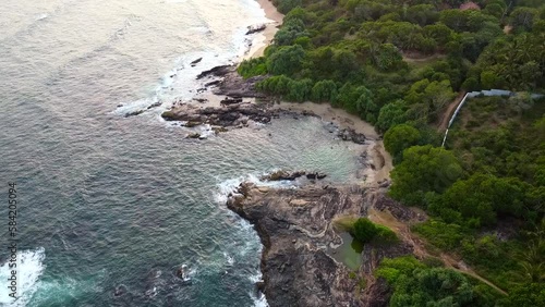 Aerial view from above of a beautiful hotel with a swimming pool. Calm beautiful flight video on the background for tourism, design and advertising. Sri Lanka, Sooriya Resort Spa, 12 January 2023