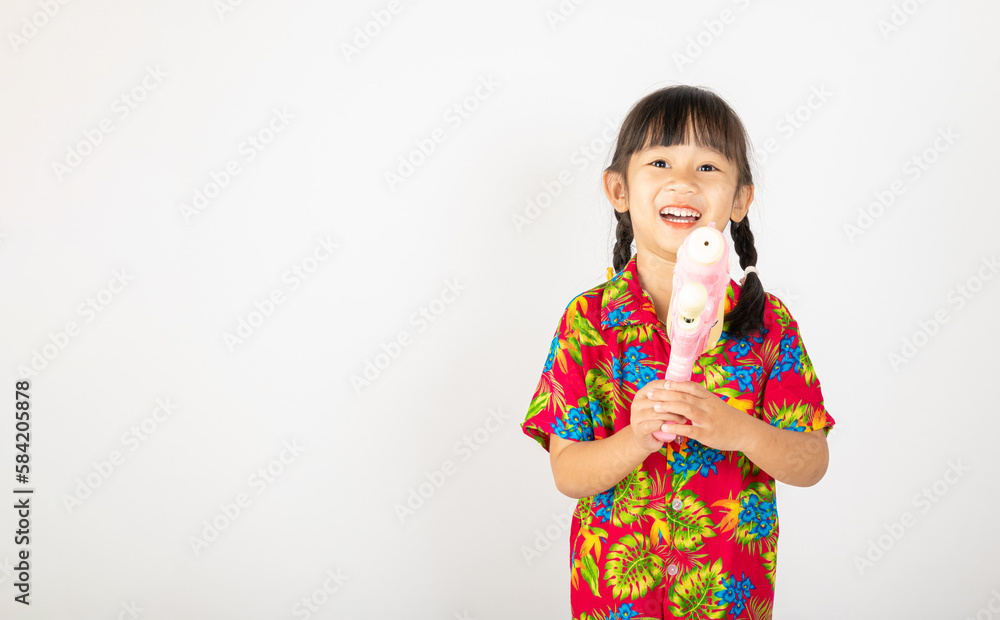 Happy Songkran Day, Asian kid girl with floral shirt hold water gun, Thai child funny hold toy water pistol and smile, isolated on white background, Thailand Songkran festival national culture concept Happy Songkran Day, Asian kid girl with floral shirt hold water gun, Thai child funny hold toy water pistol and smile, isolated on white background, Thailand Songkran festival national culture concept
