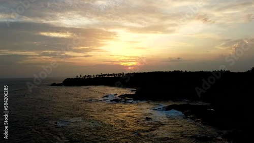 Aerial view from above of the sunset of the sea sandy shore. Ocean coast. Calm beautiful video on the background for tourism, design and advertising