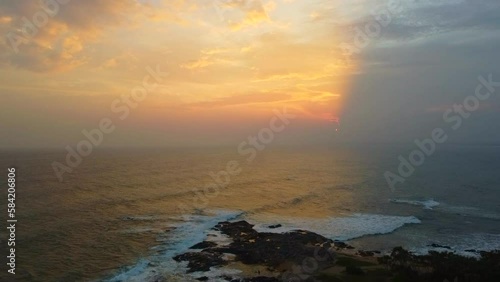 Aerial view from above of the sunset of the sea sandy shore. Ocean coast. Calm beautiful video on the background for tourism, design and advertising