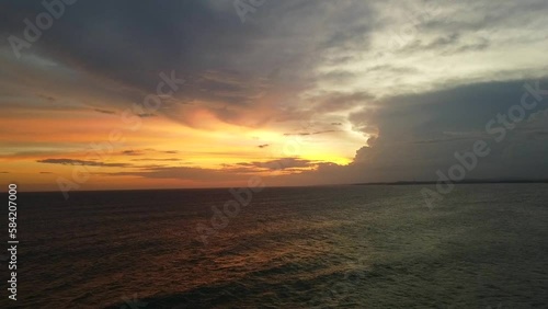 Aerial view from above of the sunset of the sea sandy shore. Ocean coast. Calm beautiful video on the background for tourism, design and advertising