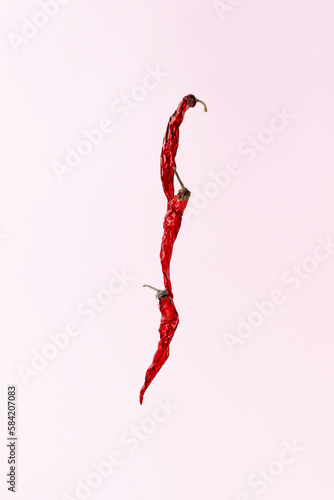 Red peppers on a pink background. Creative food concept.