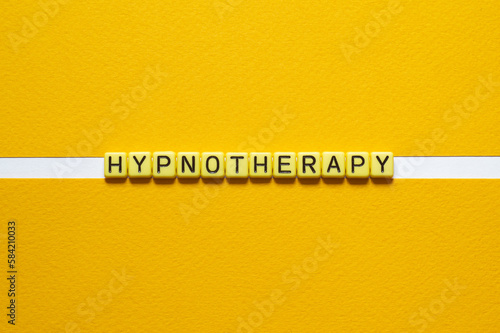 Hypnotherapy - word concept on building blocks