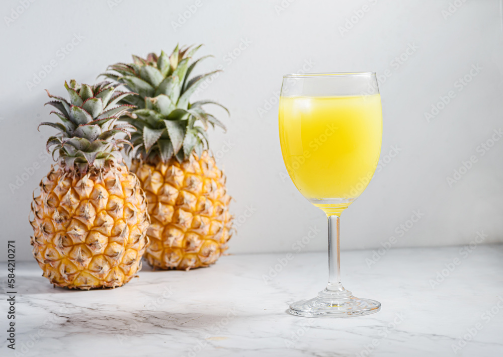 pineapple juice in a glass on a light table pineapple juice in a glass on a light table
