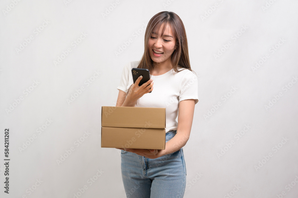 Young asian woman holding paper box and cardbord box over white background, Save earth and delivery concept. Young asian woman holding paper box and cardbord box over white background, Save earth and delivery concept.