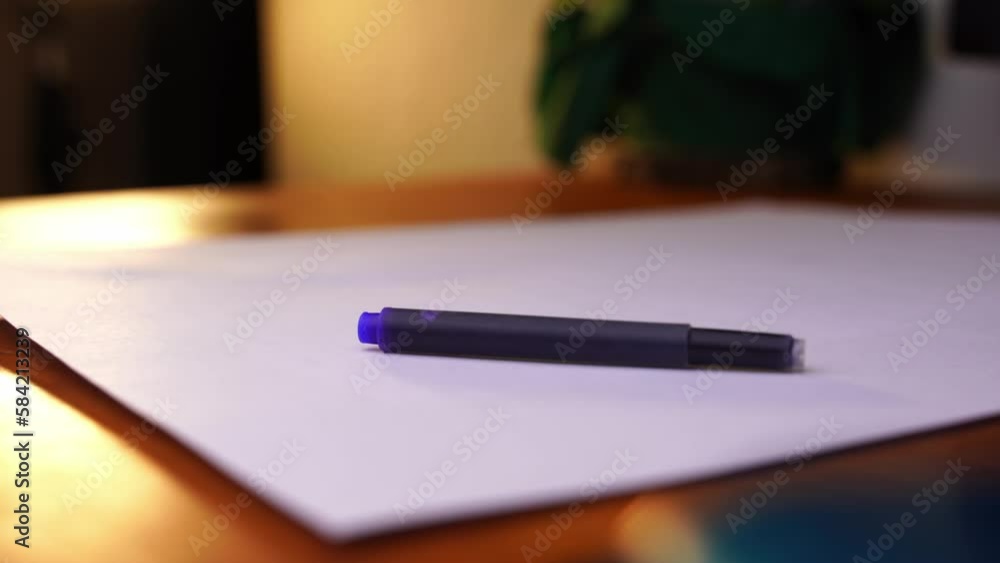 ink cartridge for a fountain pen is placed on a desk and taken away again ink cartridge for a fountain pen is placed on a desk and taken away again