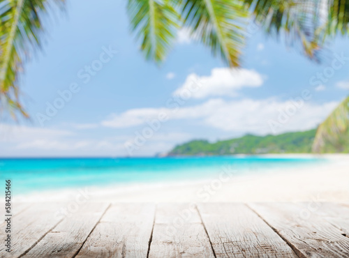 Empty wooden table or pier with sunny beach and sea