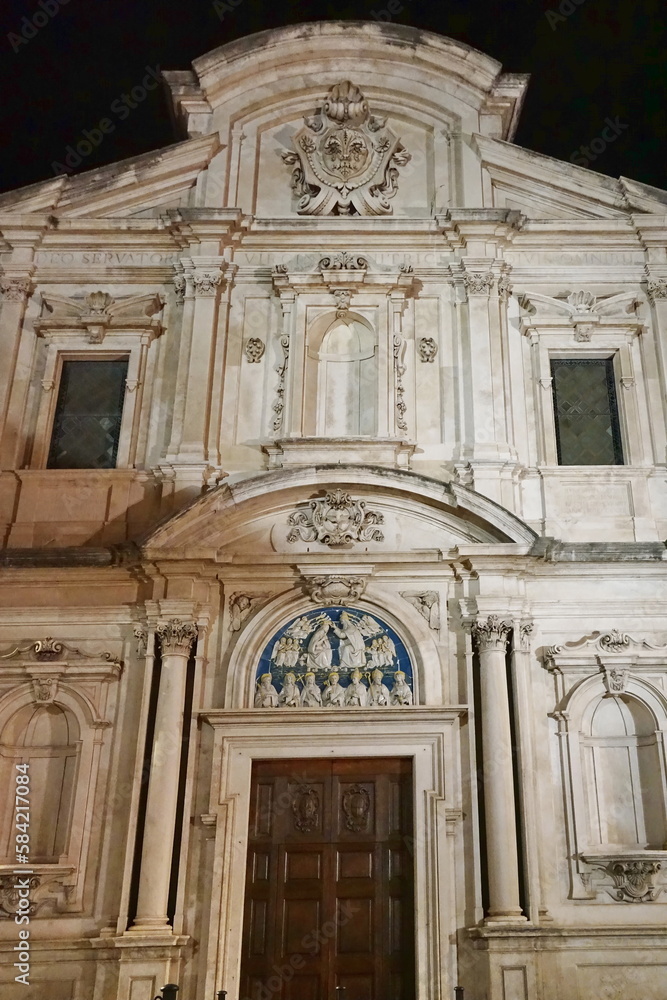 Facade of Ognissanti church at night in Florence, Tuscany, Italy
