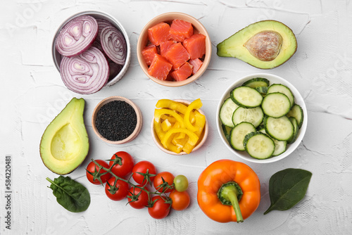 Ingredients for poke bowl on white textured table, flat lay