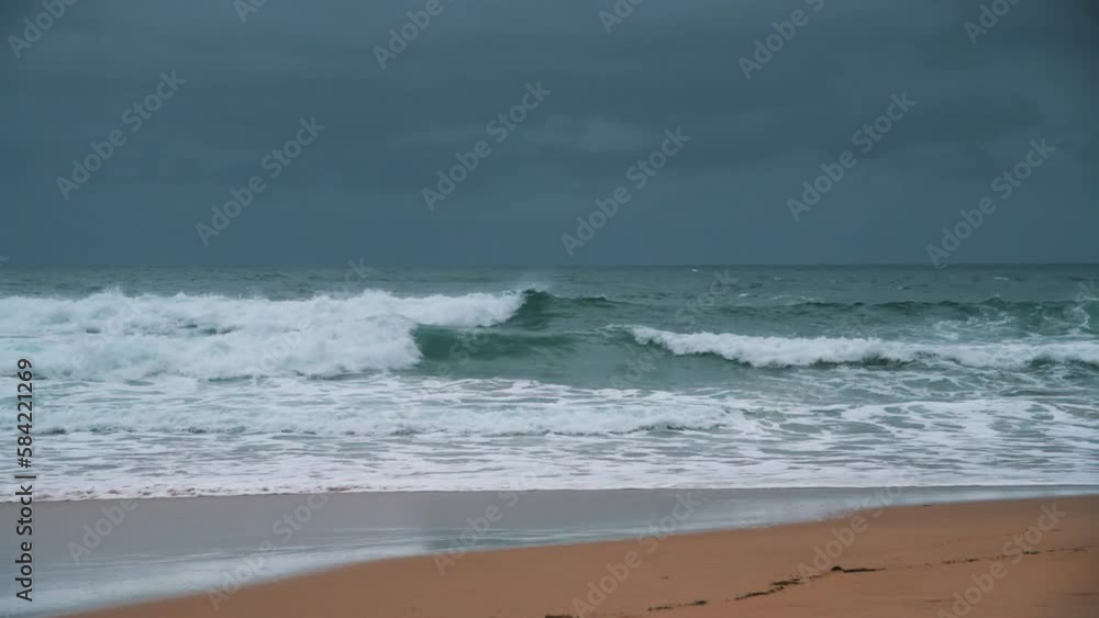 Sunrise with rain clouds and good sized waves at Macmasters Beach on the Central Coast, NSW, Australia. Sunrise with rain clouds and good sized waves at Macmasters Beach on the Central Coast, NSW, Australia.