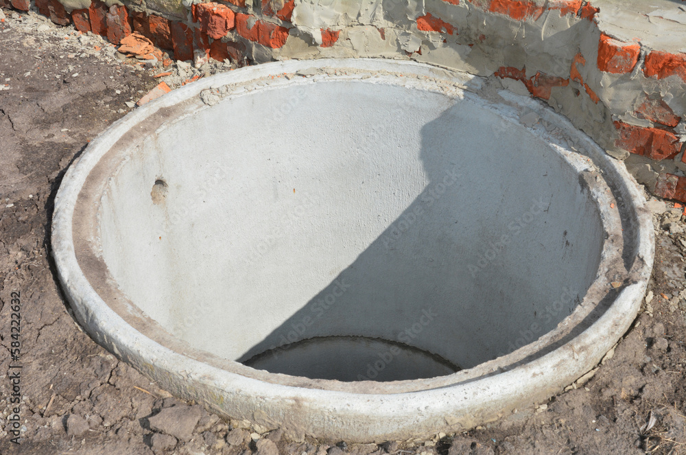 Concrete septic tank riser installation outdoors. Close up on septic ...