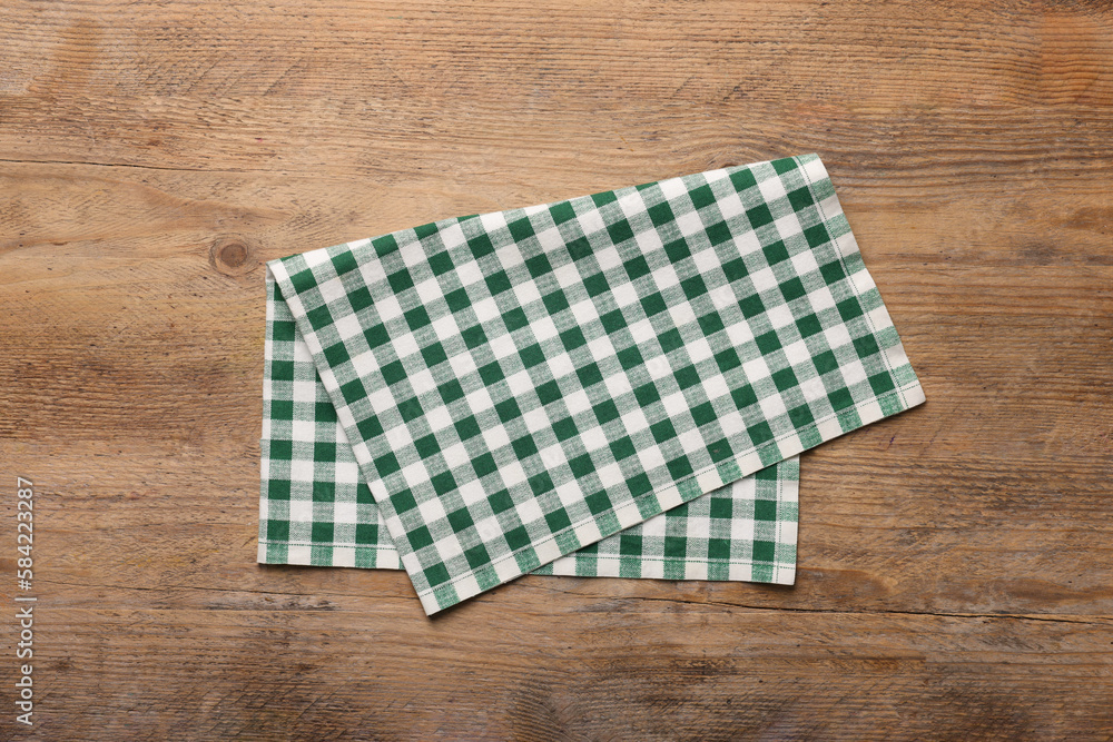 Checkered tablecloth on wooden table, top view Checkered tablecloth on wooden table, top view