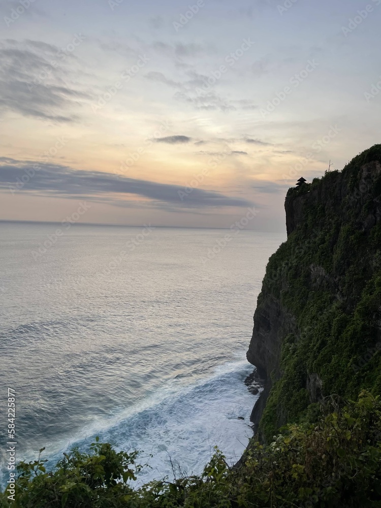 Breathtaking sunset view by the ocean from the mountains of Bali