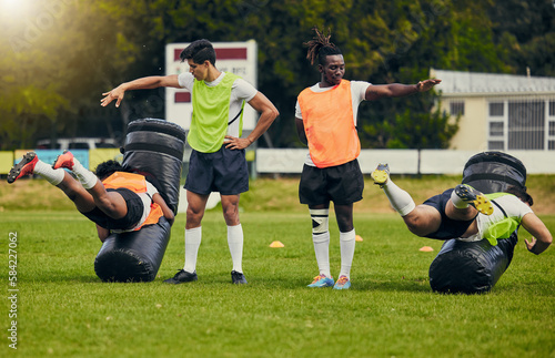 Fototapeta Naklejka Na Ścianę i Meble -  Rugby, tackle and men training on field with equipment ready for match, practice and sport games. Fitness, teamwork and male athletes for warm up performance, exercise and workout for competition