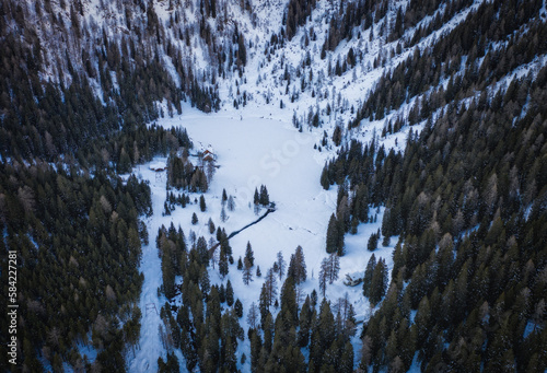 Frozen Lago Ritorto in January 2023, Madonna di Campiglio, Trentino, Italy. Aerial drone view. photo