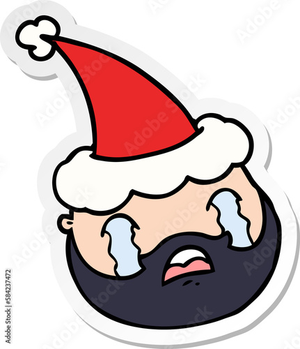 sticker cartoon of a male face with beard wearing santa hat photo