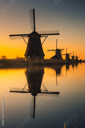 Morning among the windmills in Kinderdijk - one of the most characteristic places in the Netherlands. The beautiful spring adds charm to this place.