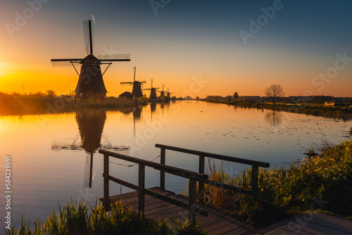 Morning among the windmills in Kinderdijk - one of the most characteristic places in the Netherlands. The beautiful spring adds charm to this place. photo
