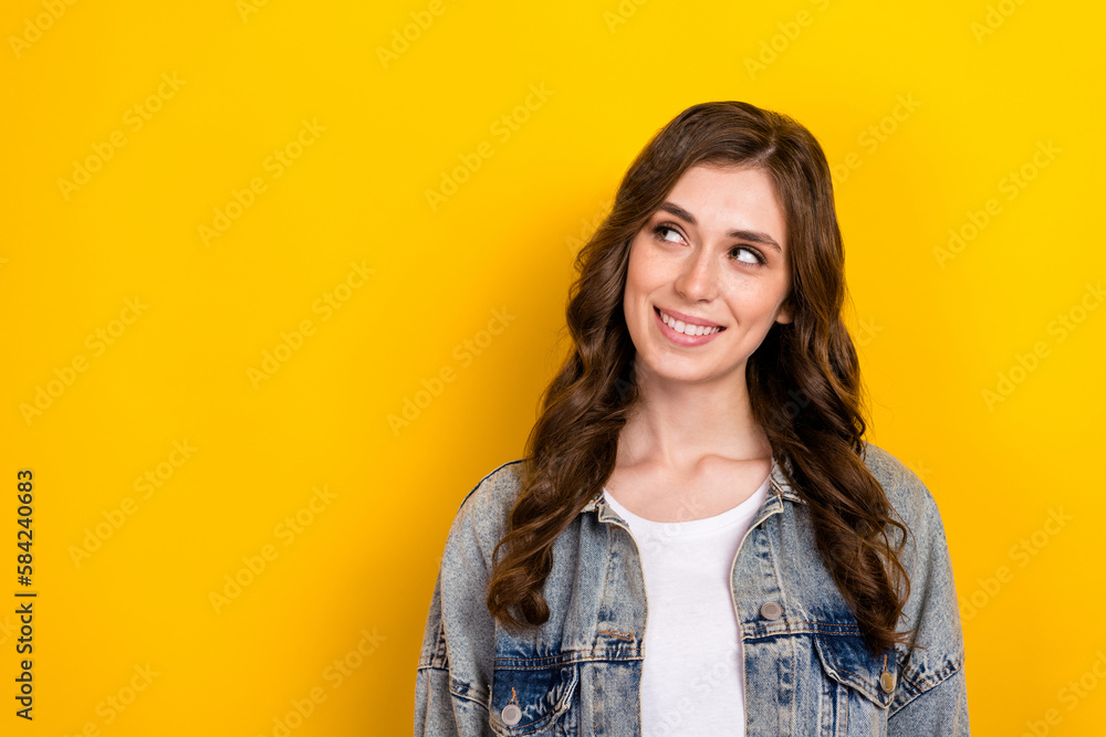 Portrait of cheerful adorable minded girl beaming smile look empty space isolated on yellow color background Portrait of cheerful adorable minded girl beaming smile look empty space isolated on yellow color background