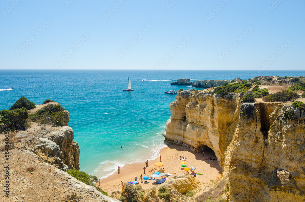 Beautiful landscape with golden limestone cliffs, Atlantic ocean and Rabbit Beach (Praia da Coelha) in Albufeira, District Faro, Algarve, Southern Portugal