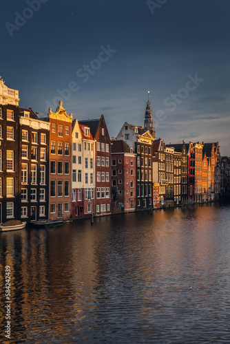 Canals in Amsterdam - the capital of the Netherlands in a night scenery. The huge amount of colors adds a beautiful look to this architecture.