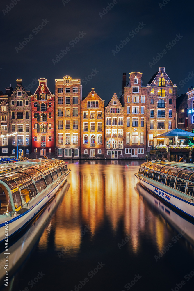 Canals in Amsterdam - the capital of the Netherlands in a night scenery. The huge amount of colors adds a beautiful look to this architecture.