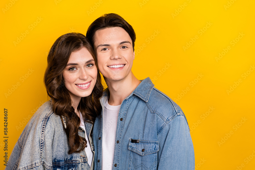 Portrait of two idyllic peaceful partners toothy smile touch heads empty space isolated on yellow color background Portrait of two idyllic peaceful partners toothy smile touch heads empty space isolated on yellow color background