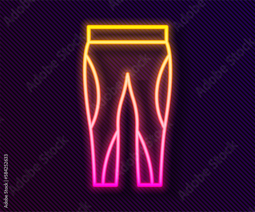 Glowing neon line Leggings icon isolated on black background. Vector