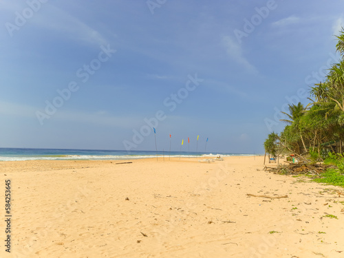 Fototapeta Naklejka Na Ścianę i Meble -  Beautiful sand beach and turquoise water. Summer holiday beach background. Ocean waves on empty tropical sand beach. Vertical background