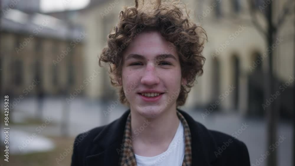 Close-up satisfied gamer taking off VR headset smiling looking at camera. Portrait of happy Caucasian young man posing on city street. Gaming and lifestyle concept Close-up satisfied gamer taking off VR headset smiling looking at camera. Portrait of happy Caucasian young man posing on city street. Gaming and lifestyle concept
