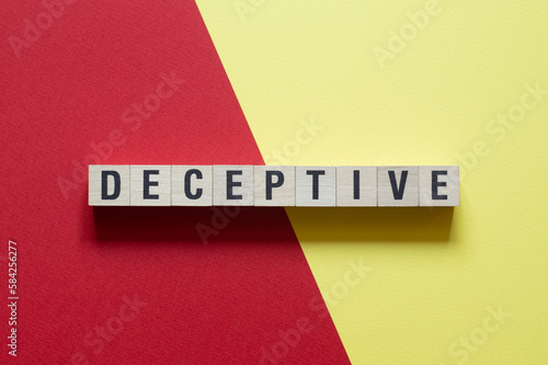 Deceptive - word concept on cubes, text